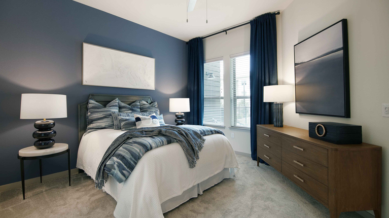 Primary bedroom with ample natural light and ceiling fan
