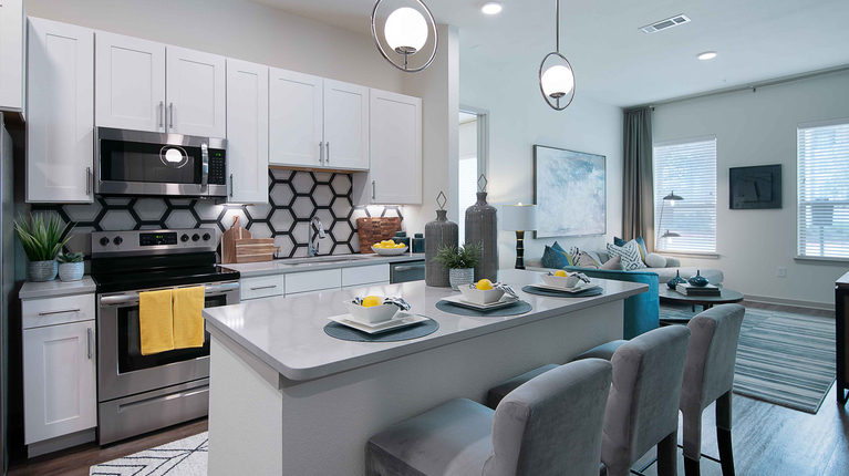 Modern kitchen with quartz countertops and ceramic tile backsplash