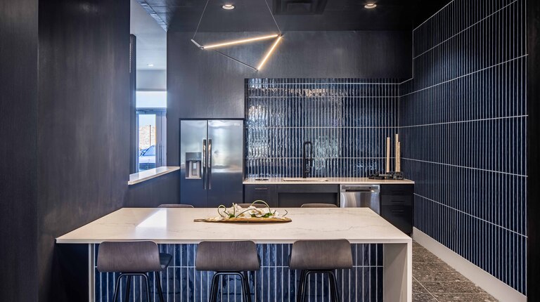 Resident lounge with gathering spaces and kitchen