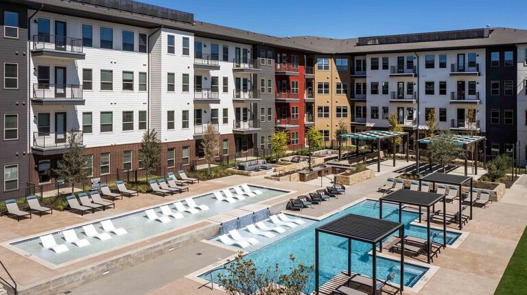 Two-tiered pool with poolside cabanas